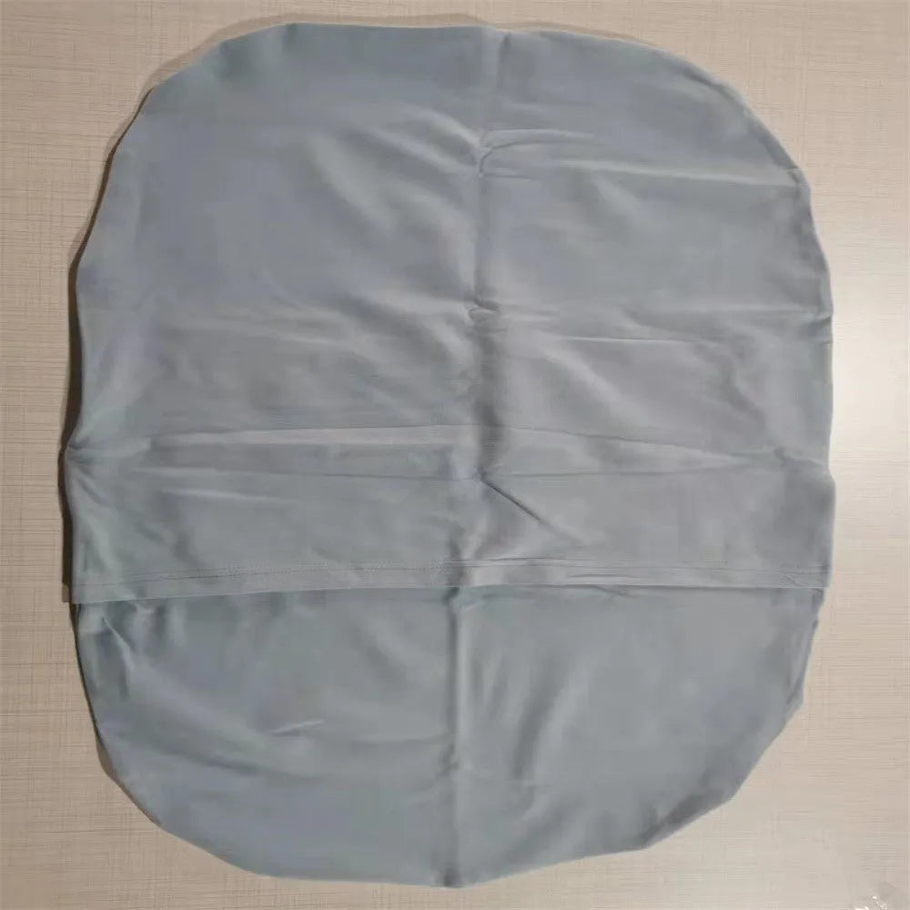 Beige portable cotton baby nest crib for newborns on a neutral background