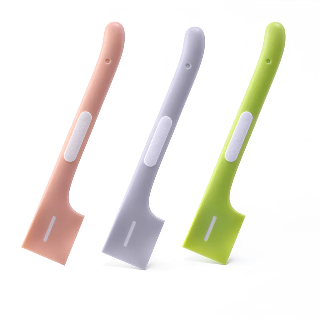 Green long-handled pet feeding spoon for scraping wet food from cans.