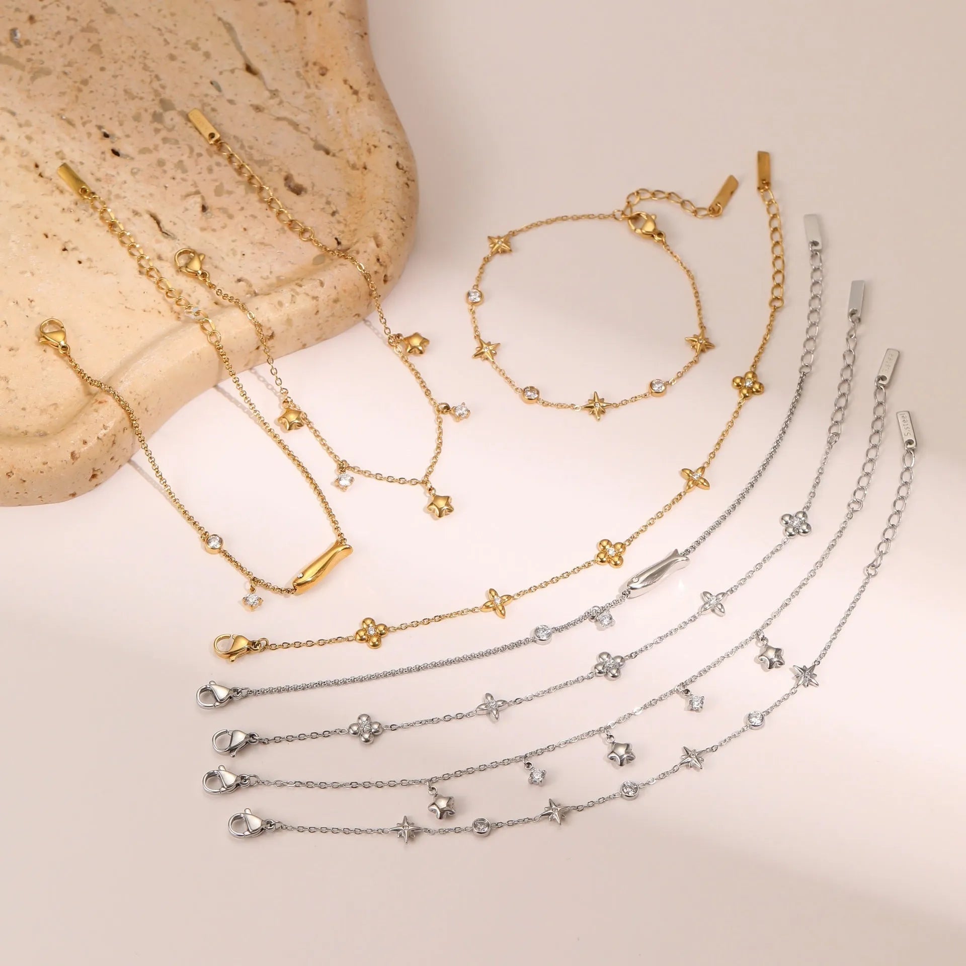 Gold electroplated stainless steel bracelet with a geometric star-shaped pendant.