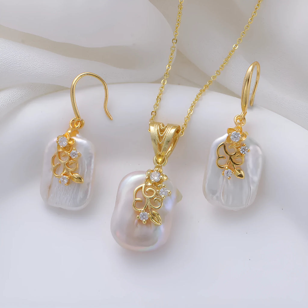 Women's baroque shaped pearl ornament necklace and earrings set with geometric O-ring chain on display
