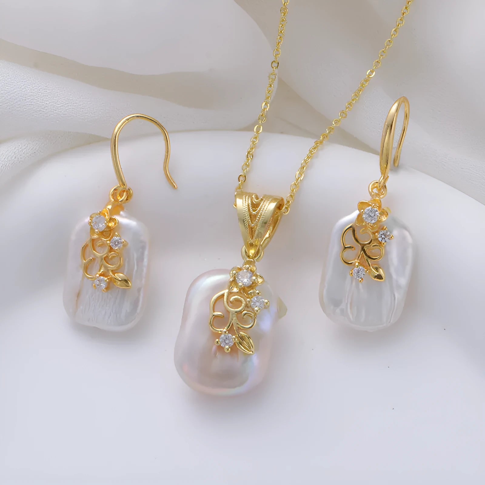 Women's baroque shaped pearl ornament necklace and earrings set with geometric O-ring chain on display