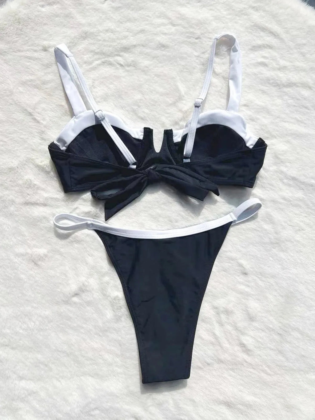 Black low waist bikini swimsuit with stitching split design on mannequin showing front and back views