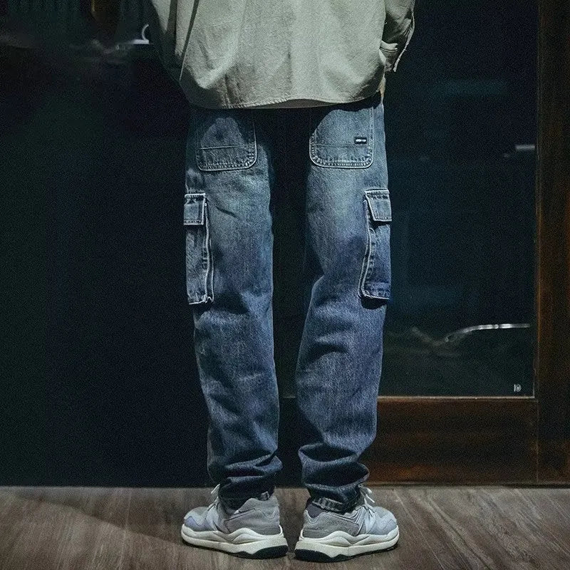 Blue men's loose straight-leg jeans with a zip fly on a neutral background.