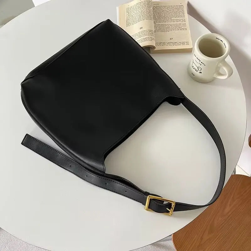 Women's soft PU leather shoulder bag with swing threads design in black or brown, showing 28x32x12cm dimensions