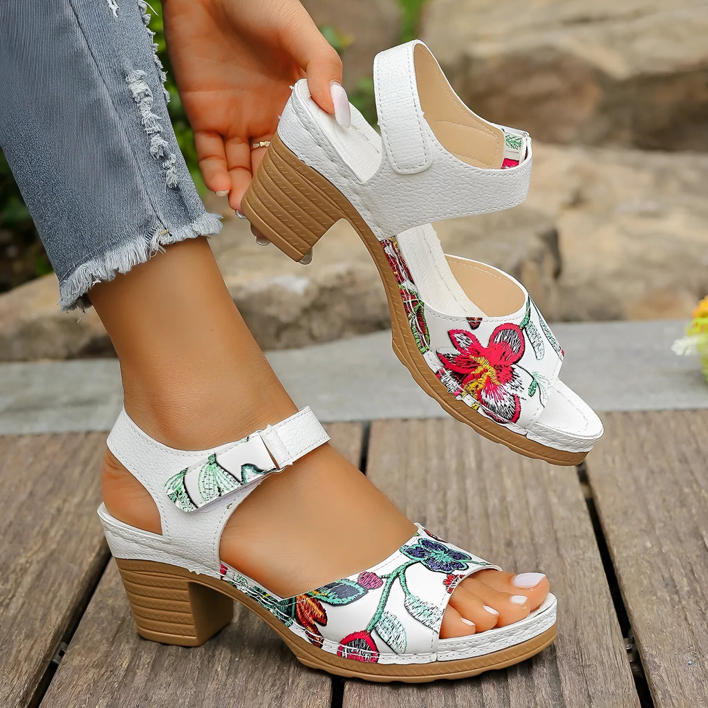 White women's casual high heel sandals with a Velcro strap buckle on a rubber sole.