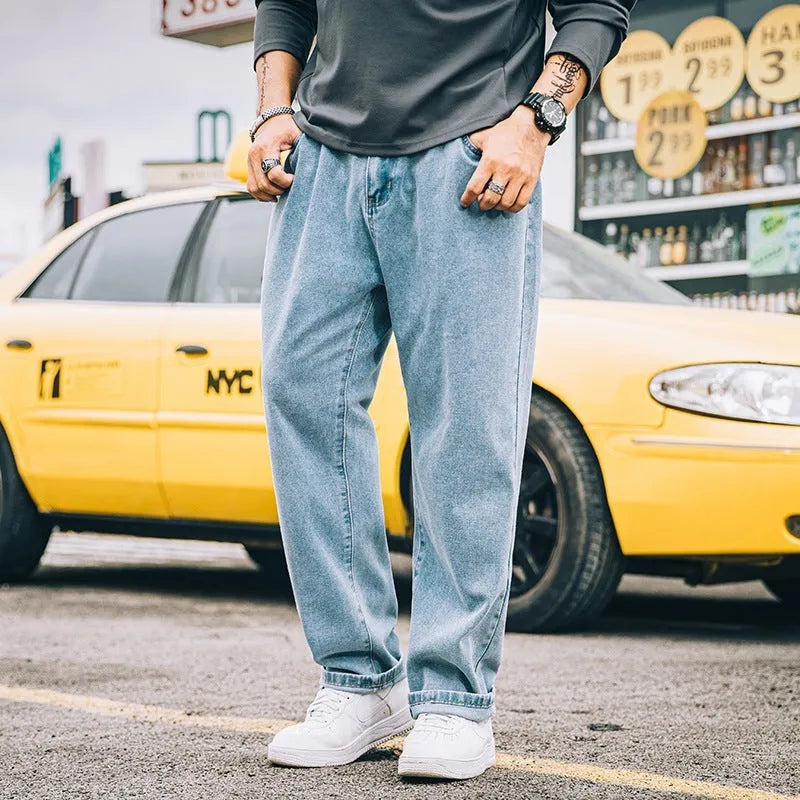 Men's loose fit straight leg jeans in cotton denim shown in dark blue, mid waist with zipper fly