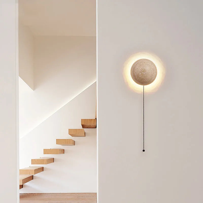 Vintage semicircle wall lamp with yellow cave stone shade and iron base, showing pull switch.