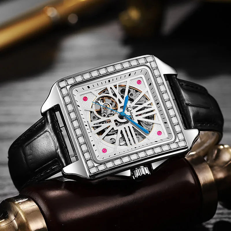 Men's square automatic watch with diamond studs on case, available in black or white with leather or steel strap.