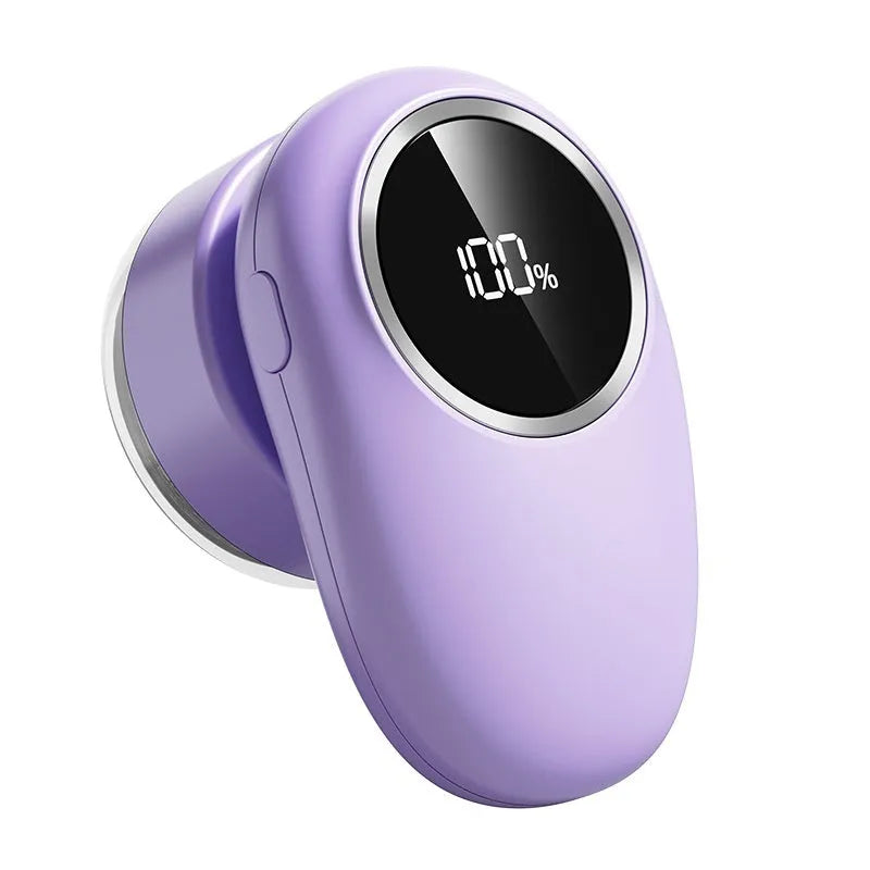 Beige and purple rechargeable pet hair trimmer with digital display and replacement cutter heads on a table.