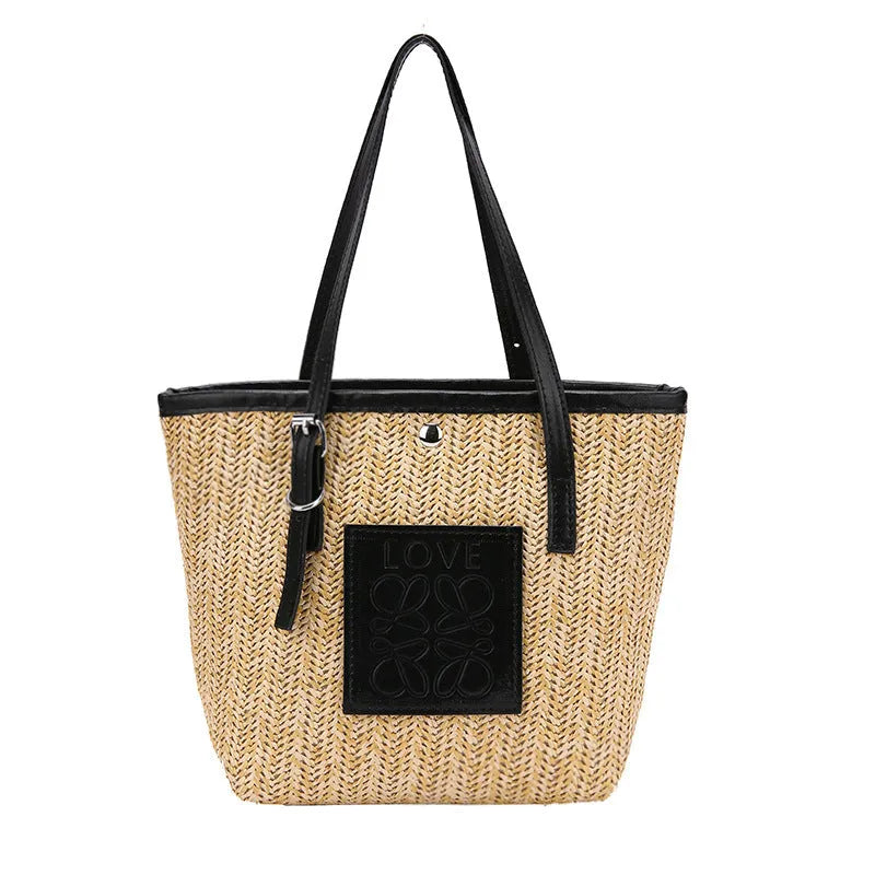 Straw woven women's shoulder bag in black with sewing thread detailing and three-dimensional pockets