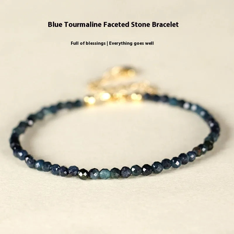 Blue tourmaline 3mm bead bracelet with spacer design on wrist