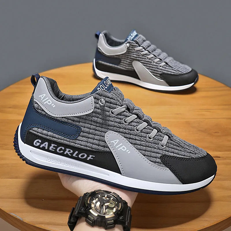 Men's grey and green mesh low-top lace-up running shoes on a white background.