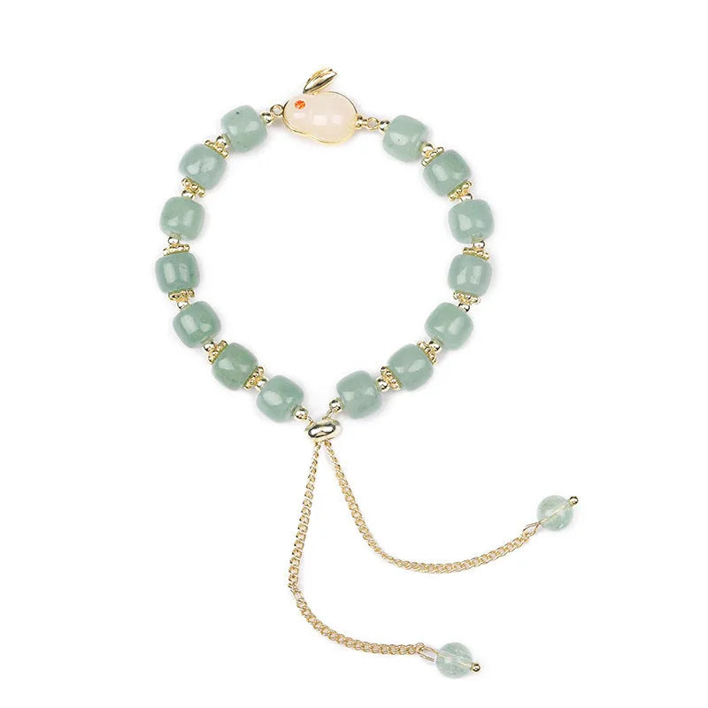 Rabbit charm bracelet with green aventurine and strawberry quartz stones on copper metal with gold accents