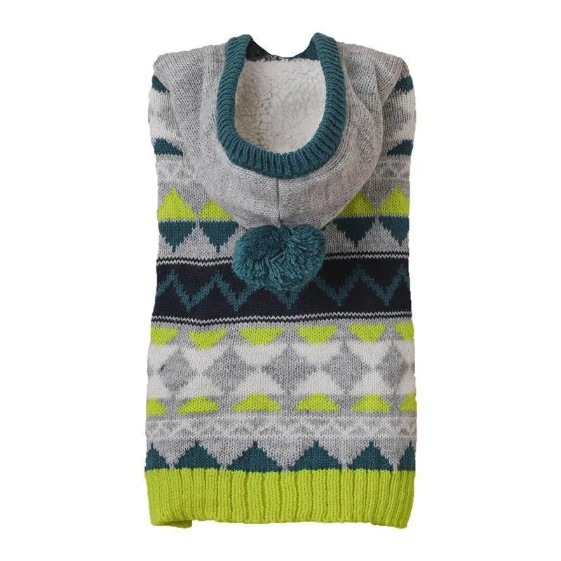 Green knitted pet sweater with diamond pattern on a small dog, showing size and texture.