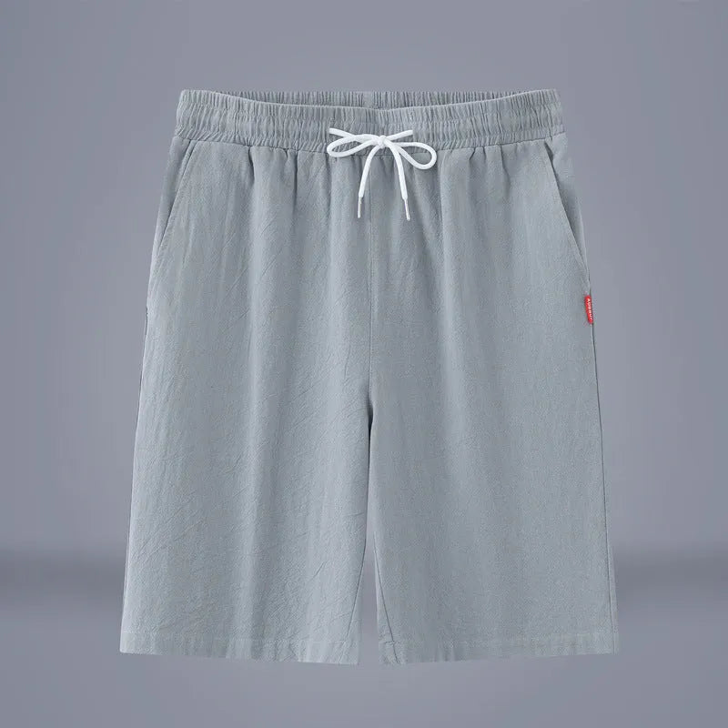 Solid colour cotton linen cropped pants with a drawstring waist on a hanger.