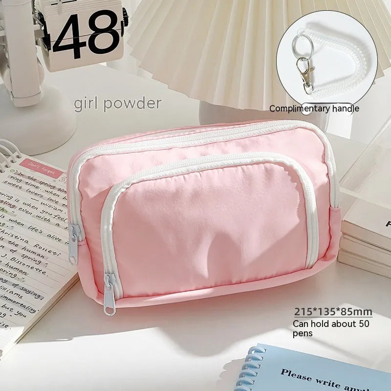 Double layer high capacity pencil case in blue with gift handle, showing zippered compartments.