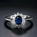 Women's electroplated copper ring with a blue zirconium flower stone on a finger.
