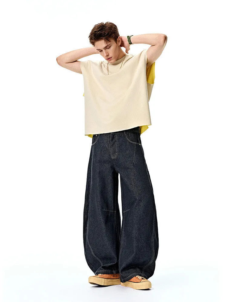 Men's wide leg denim trousers in original cow colour showing mid waist design and straight leg cut