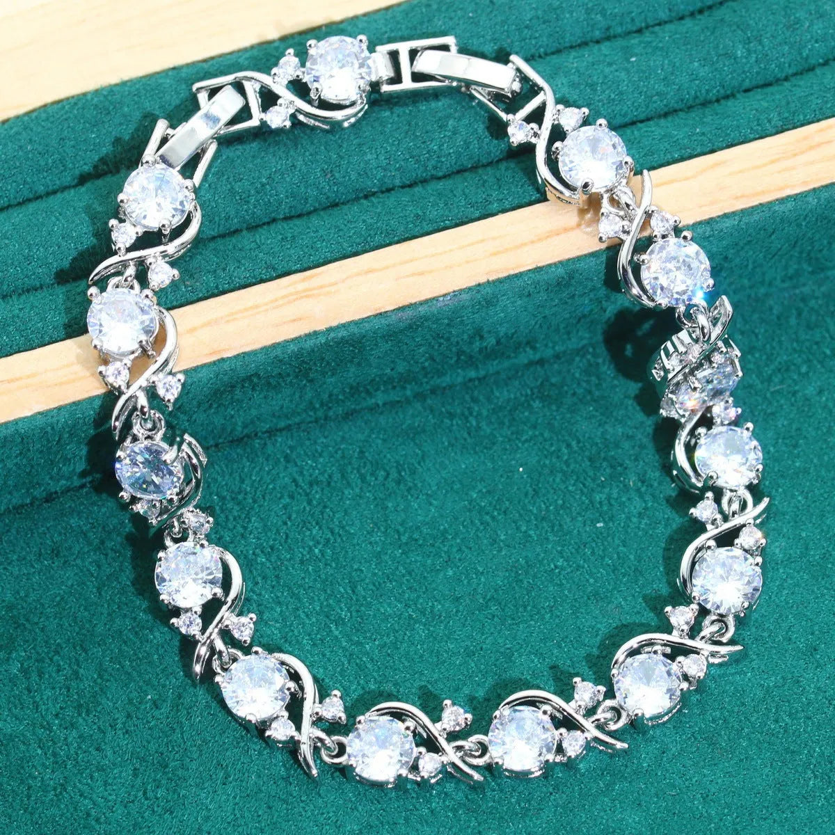 Four-piece bridal jewellery set with zircon alloy necklace, earrings, bracelet, and ring in water wave chain design