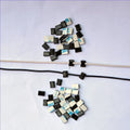 Black PA66 plastic wiring management clips for automotive and electronic cable organisation.