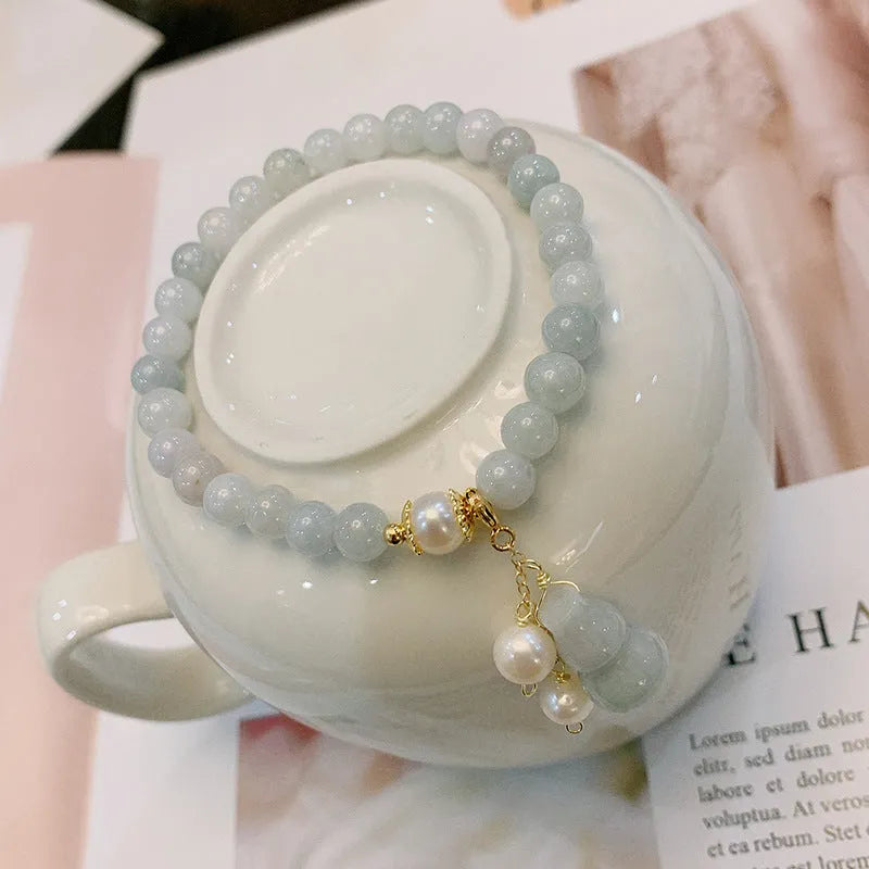 Emerald green jade bracelet with a raised gourd design in a Chinese style.