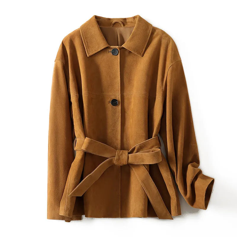Women's belted caramel cashmere coat with leather stitching and a Peter Pan collar.