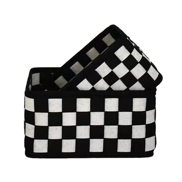 Checkerboard pattern black and white felt storage basket with folded sides.