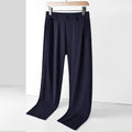 Man wearing black loose-fit straight-leg Ice Silk trousers with an elastic waistband for leisure wear.