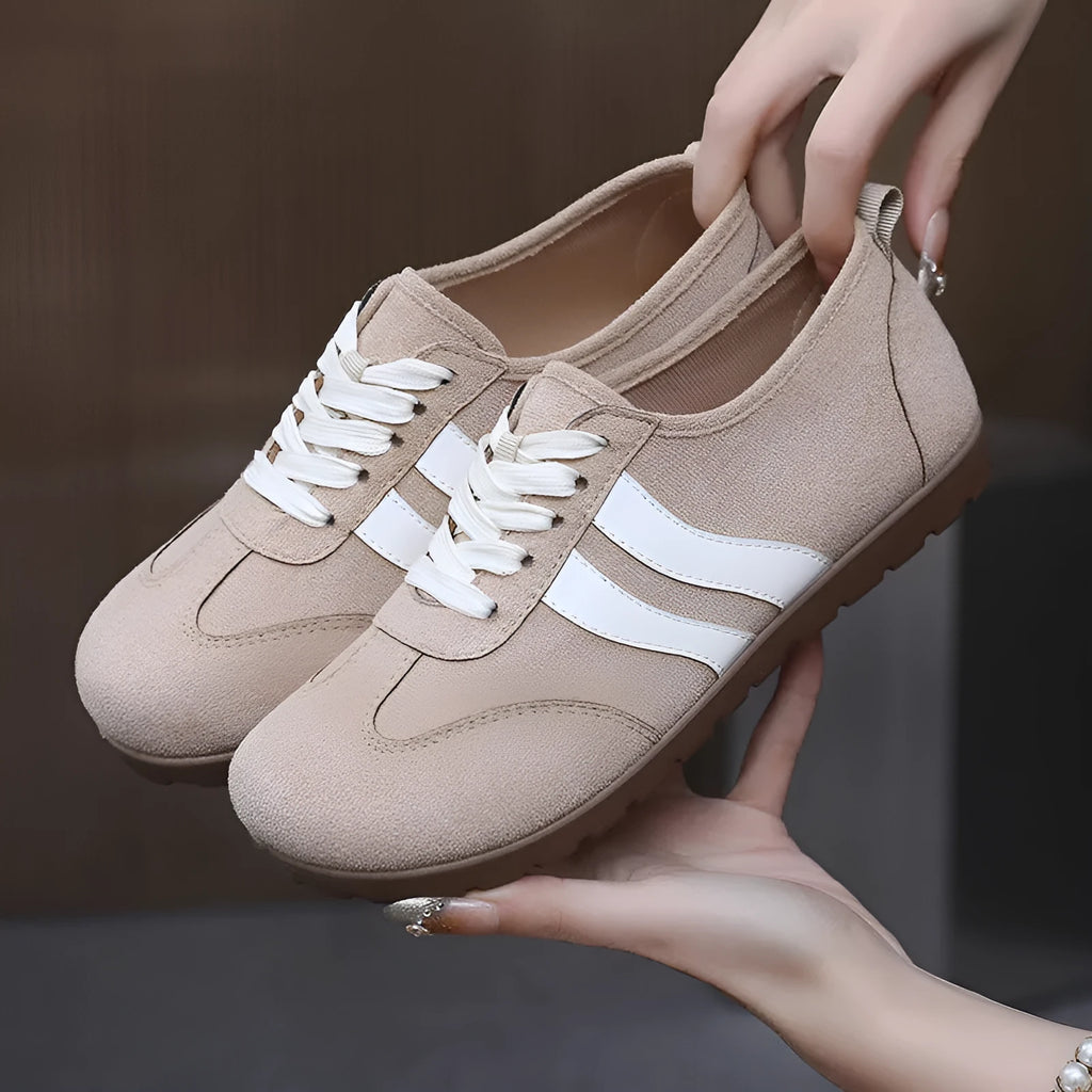 Women's dark red canvas sneakers with a flat rubber sole and round toe on a white background.