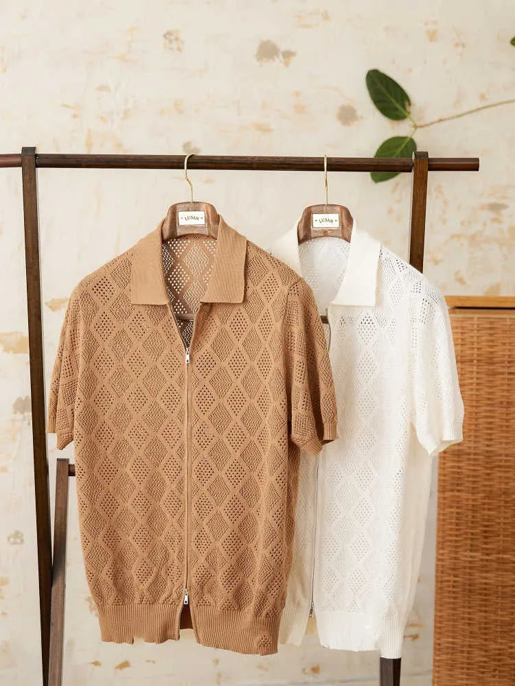 White cotton zip-front cardigan with lapel collar and short sleeves laid flat.