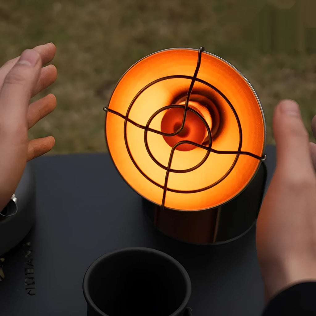 Portable outdoor heating stove with black and orange finish and automatic press ignition