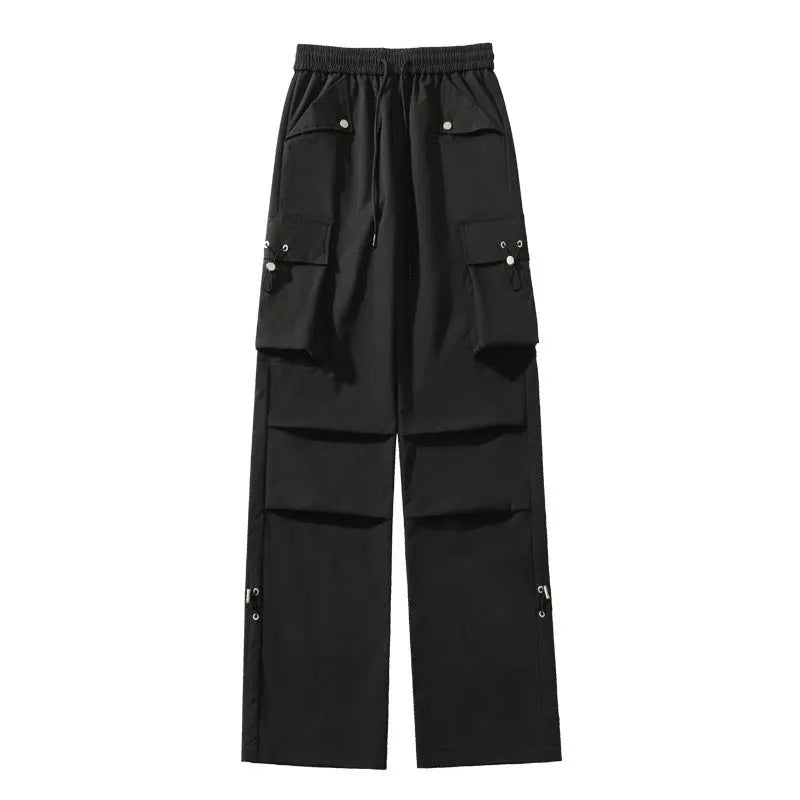 Woman wearing black waterproof plus size straight-leg trousers with a loose fit and drawstring waist.
