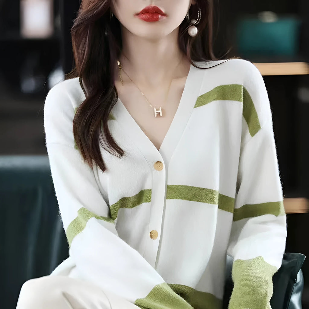 Woman wearing a slim fit V-neck knitted cardigan with a black and white 3D striped pattern