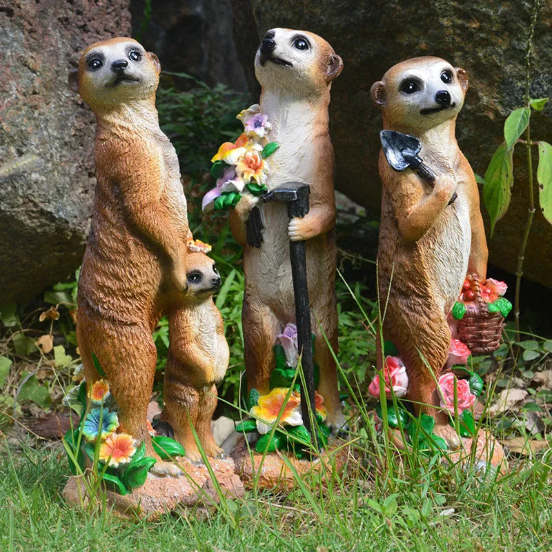 Three straw hat mongoose garden ornaments including mother and child, rake carrier, and shovel carrier designs
