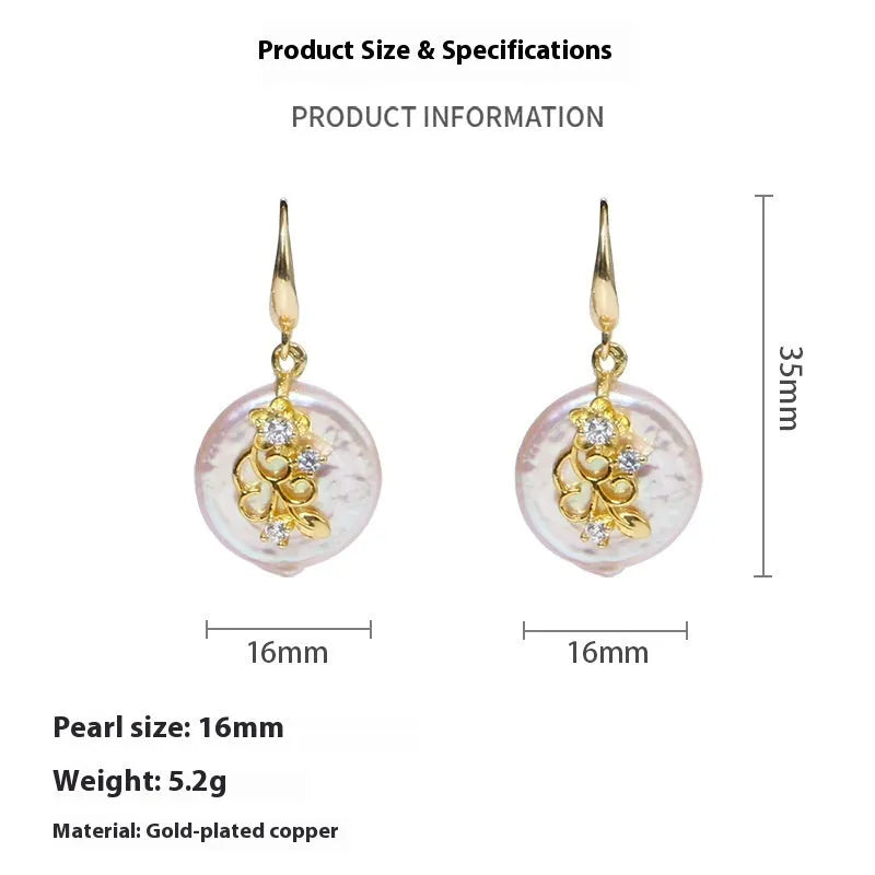 Women's baroque shaped pearl ornament necklace and earrings set with geometric O-ring chain on display