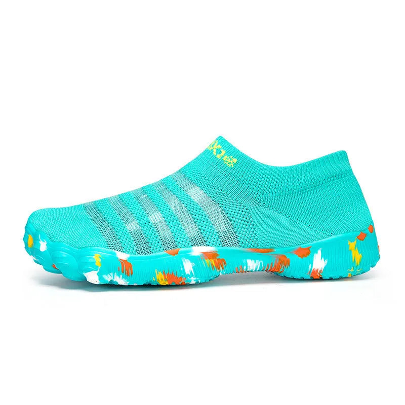 Camouflage pattern water shoes with Flyknit upper and rubber sole, shown on a rocky shore.