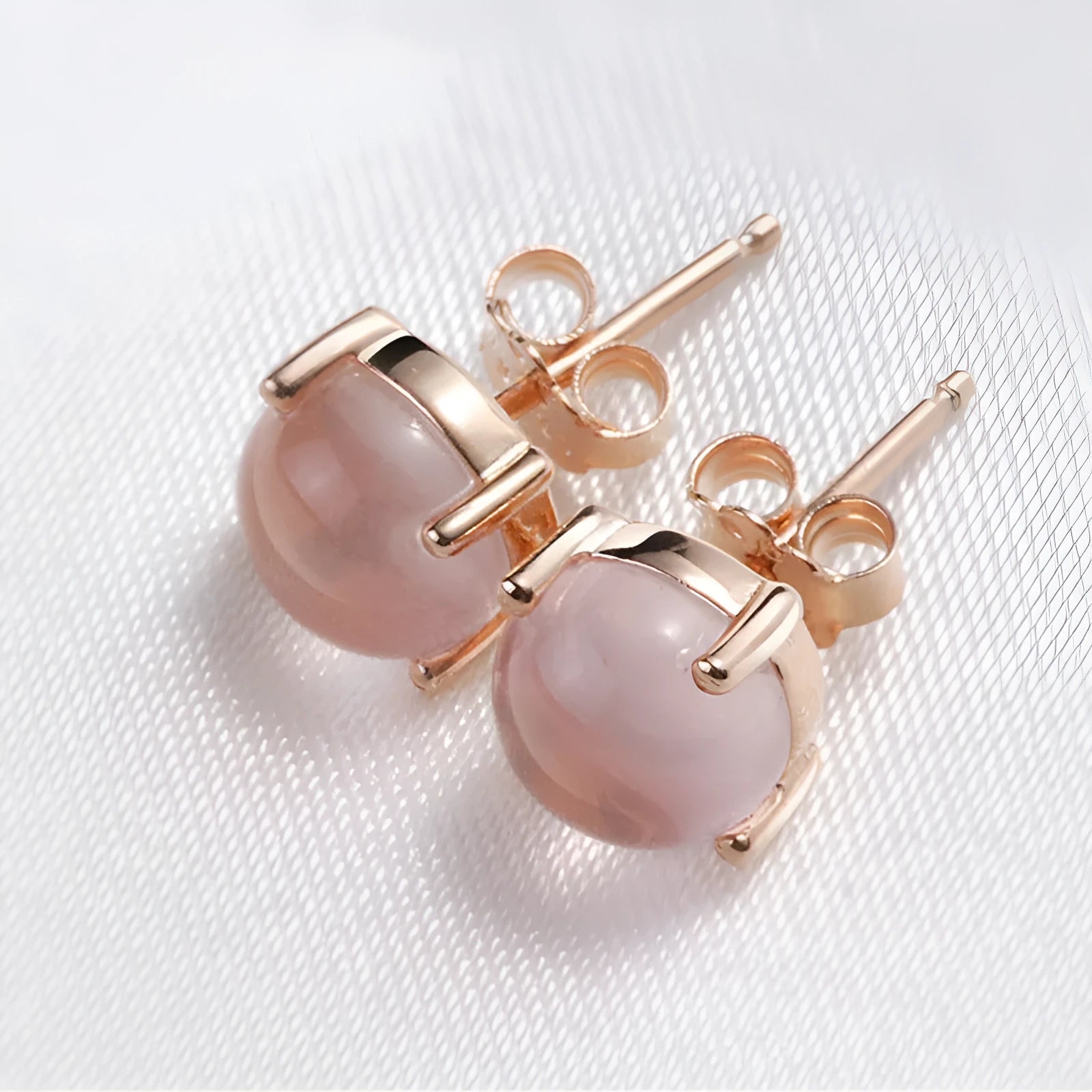 Rose gold drop shape stud earrings with synthetic quartz crystal inlay