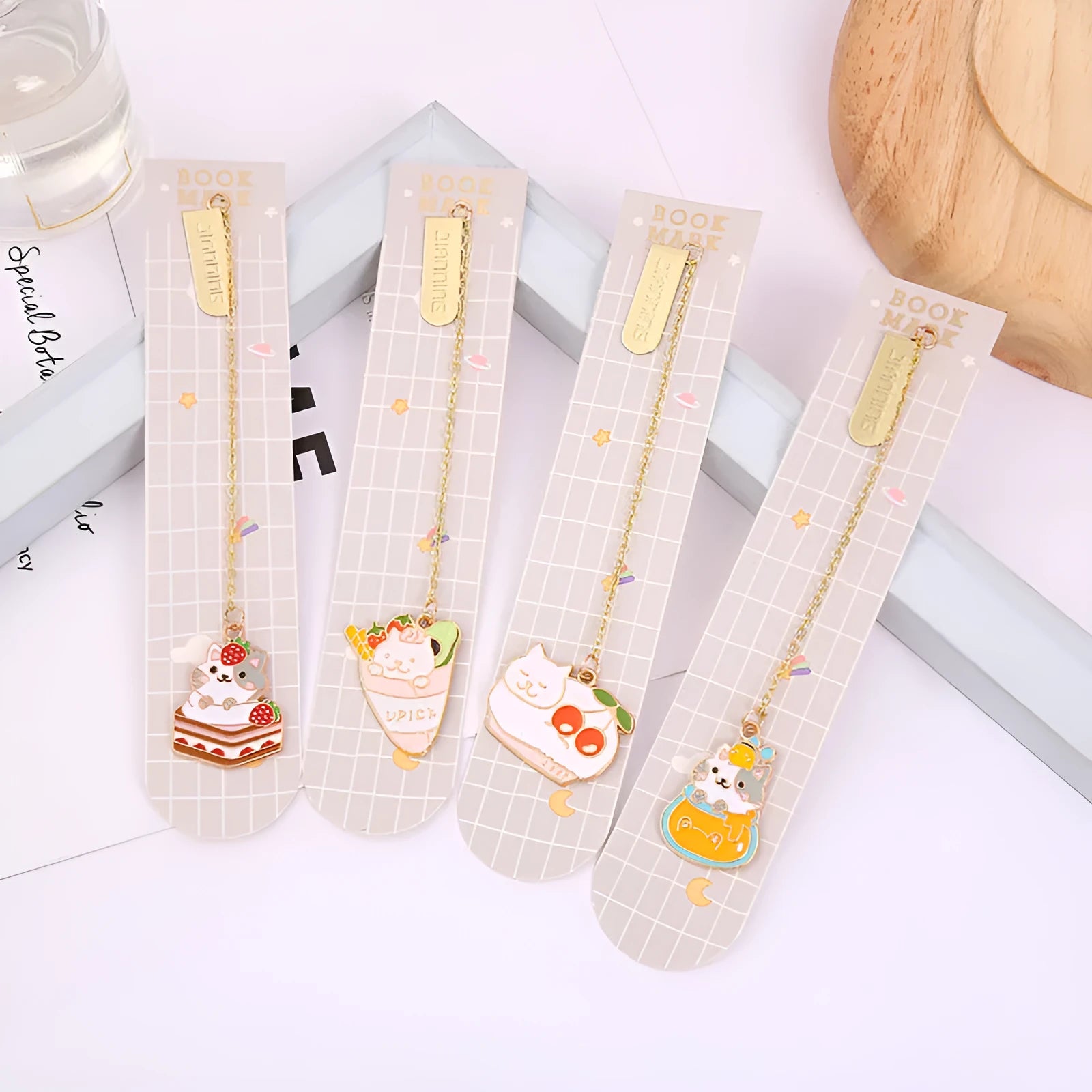 Jane Lime Foodie Cat metal bookmark with cartoon pendant in four colour variations on a white background.