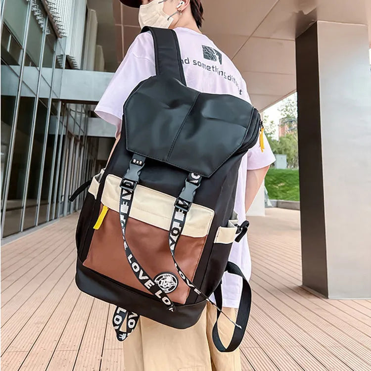 Oxford cloth backpack shown in black, green or red with handheld and shoulder straps.
