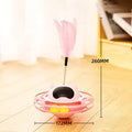 Pink cat tumbler turntable toy with self-hi feature for independent play