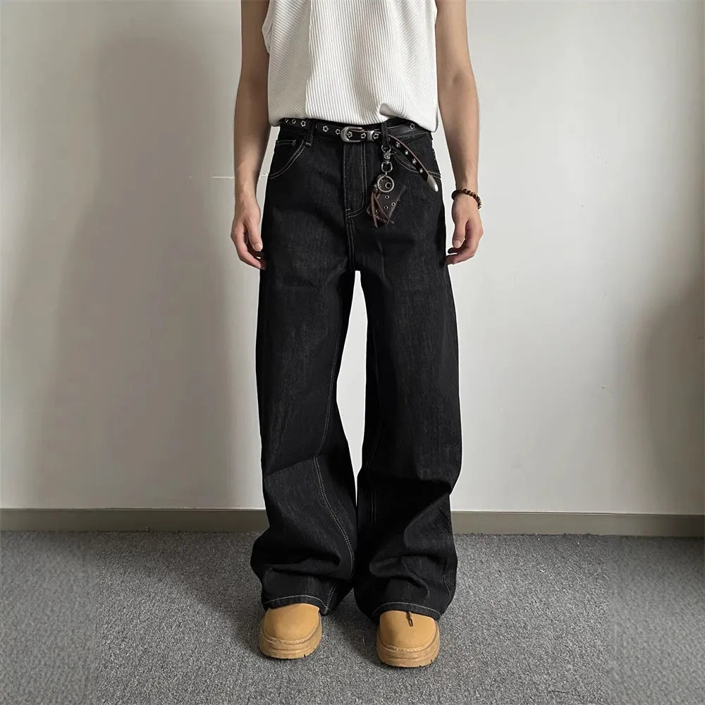 Black loose wide-leg straight-leg retro jeans on a hanger, showing zip fly and mid waist.