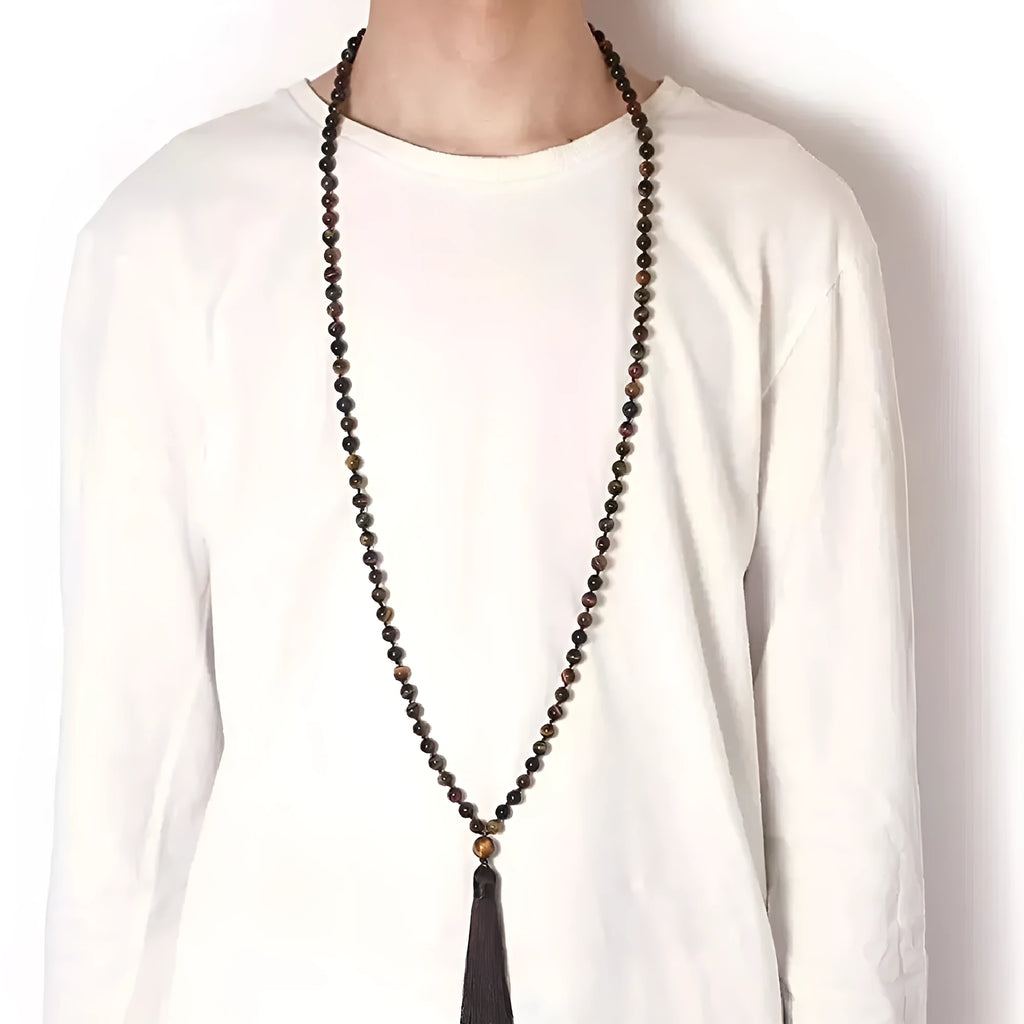 Long agate tassel necklace with geometric beads in multiple natural stone colours on a white background.