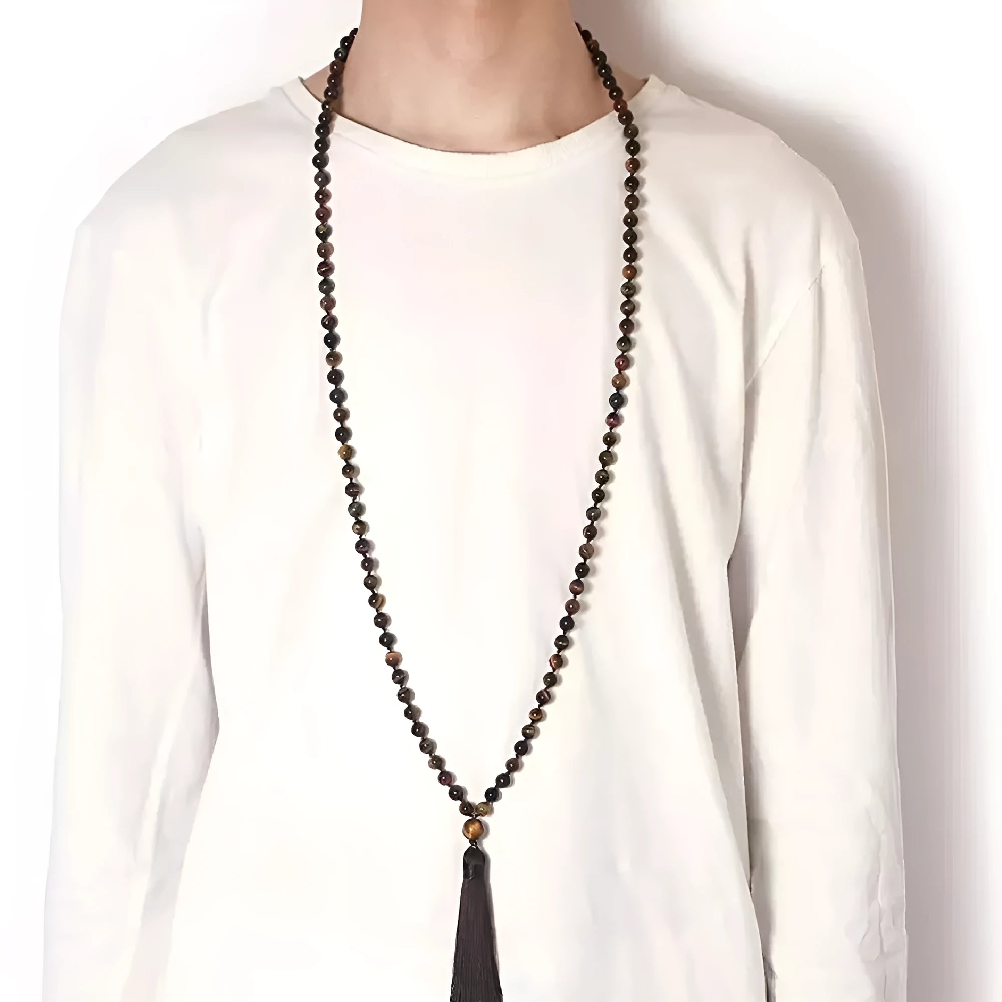 Long agate tassel necklace with geometric beads in multiple natural stone colours on a white background.
