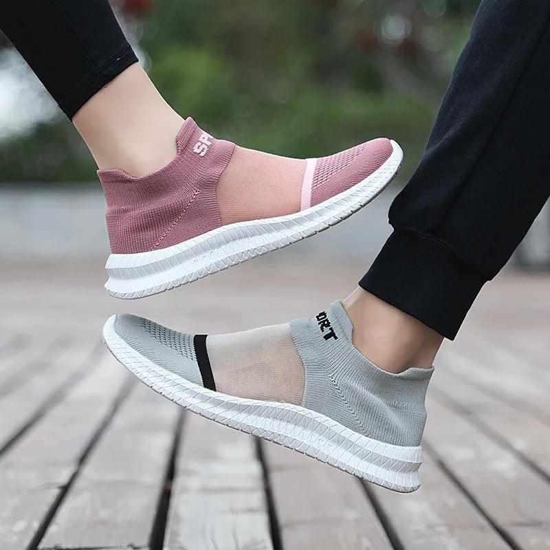 Casual beige Flyknit sports socks shoes with lace-up front and round toe on a neutral background.