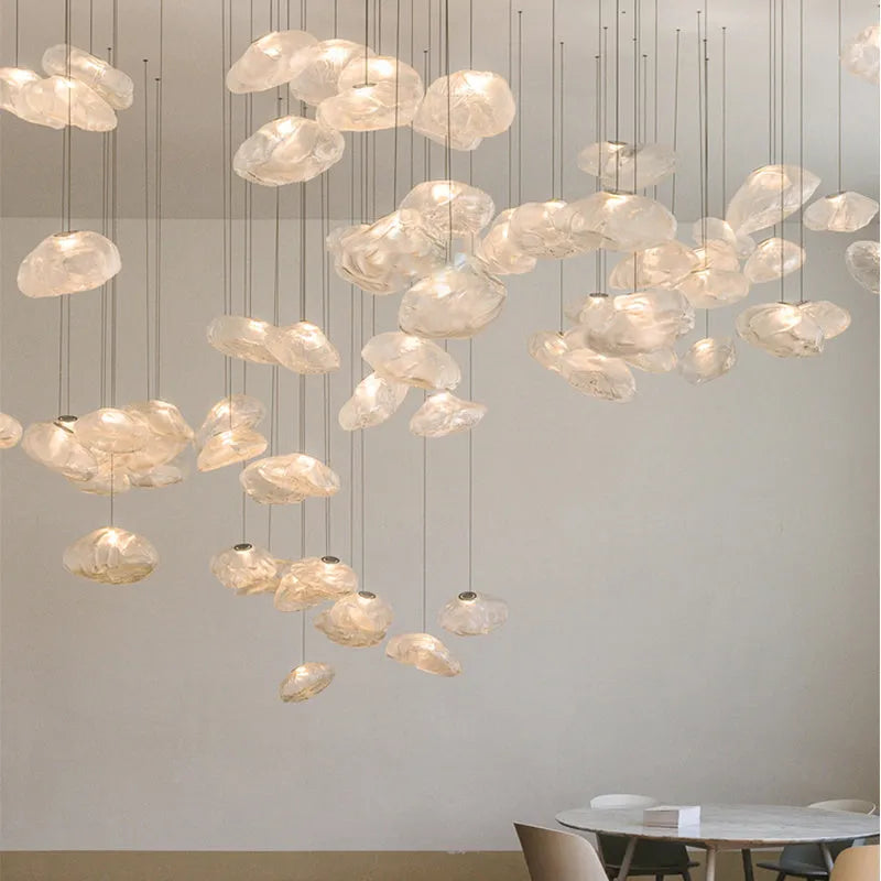Modern fabric chandelier light with glass shade in amber, clear, or smoke grey, shown in small and large sizes.