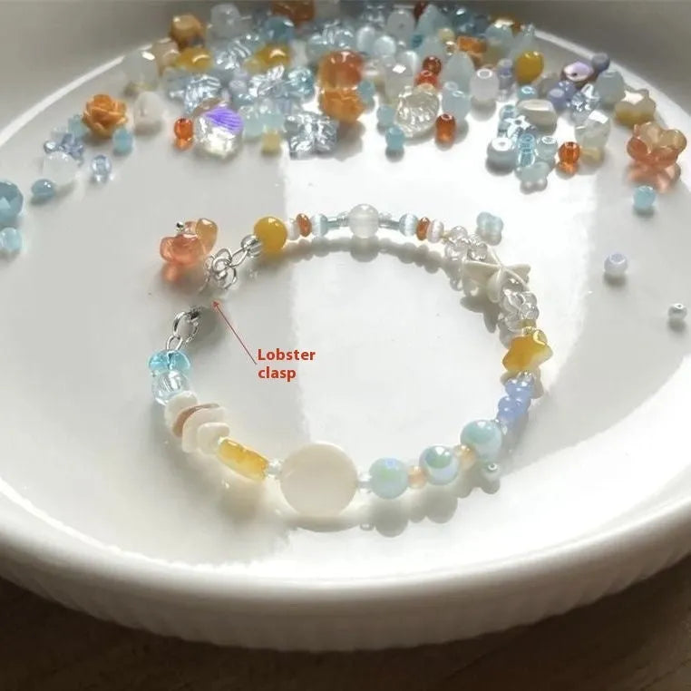 Orange alloy bracelet with diamond shape and round decorative elements on wrist