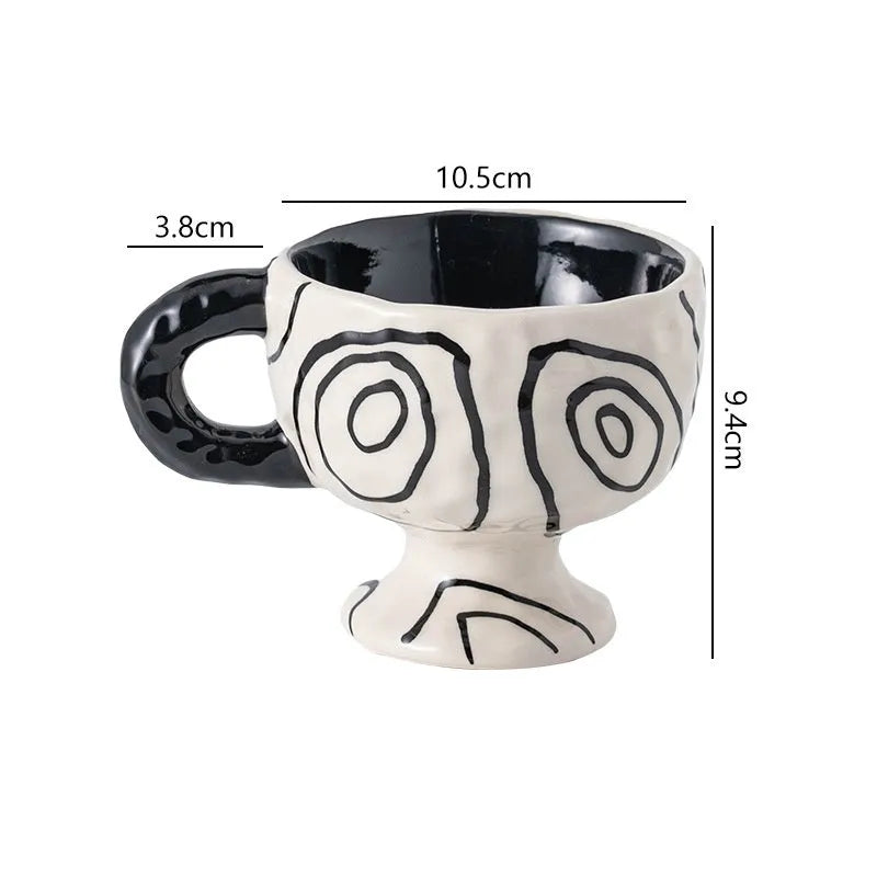Hand-pinched irregular shaped ceramic mug in a solid colour on a table