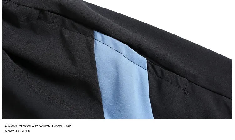 Men's black quick-drying sports shorts with grey contrast panels and elastic waistband