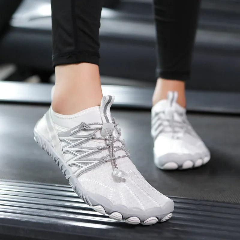 Indoor fitness training shoes in striped design with low-top profile and rubber sole.
