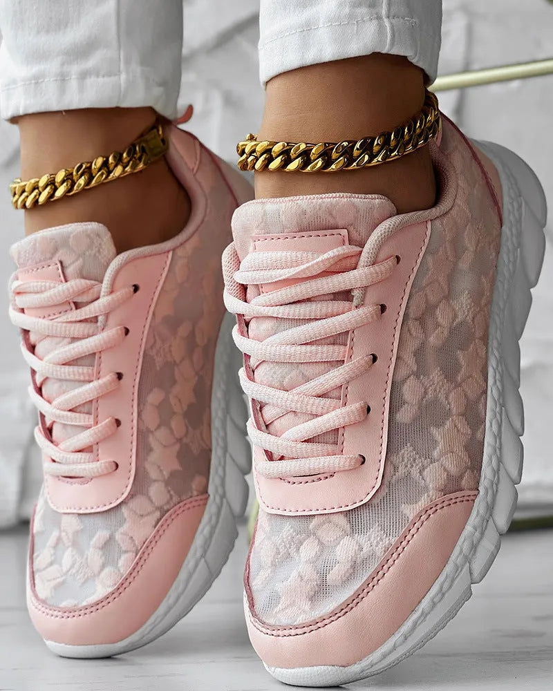Women's canvas running shoes in white, black, blue, and pink colours with flat-heel construction